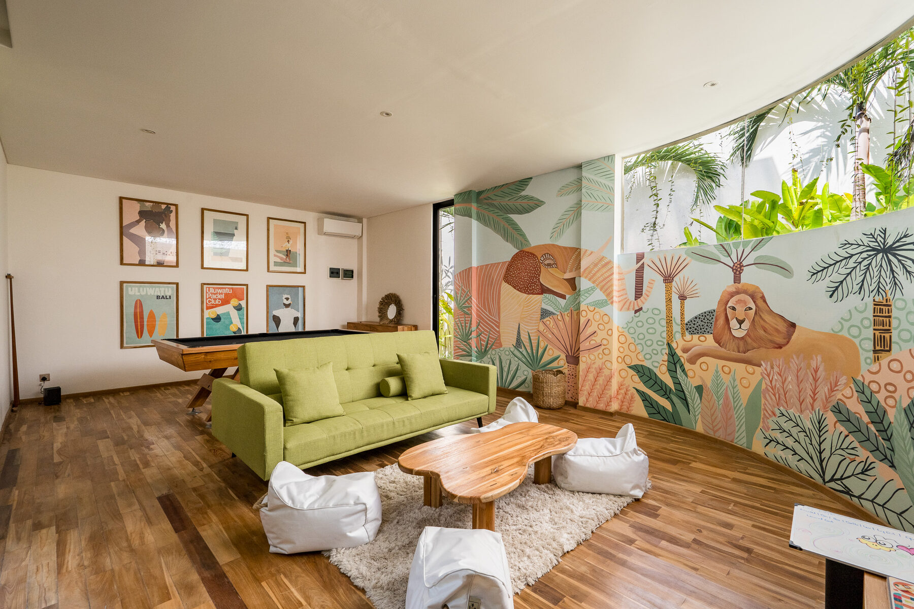 The playroom at Maison Ulu Dua with pool table and media setup.