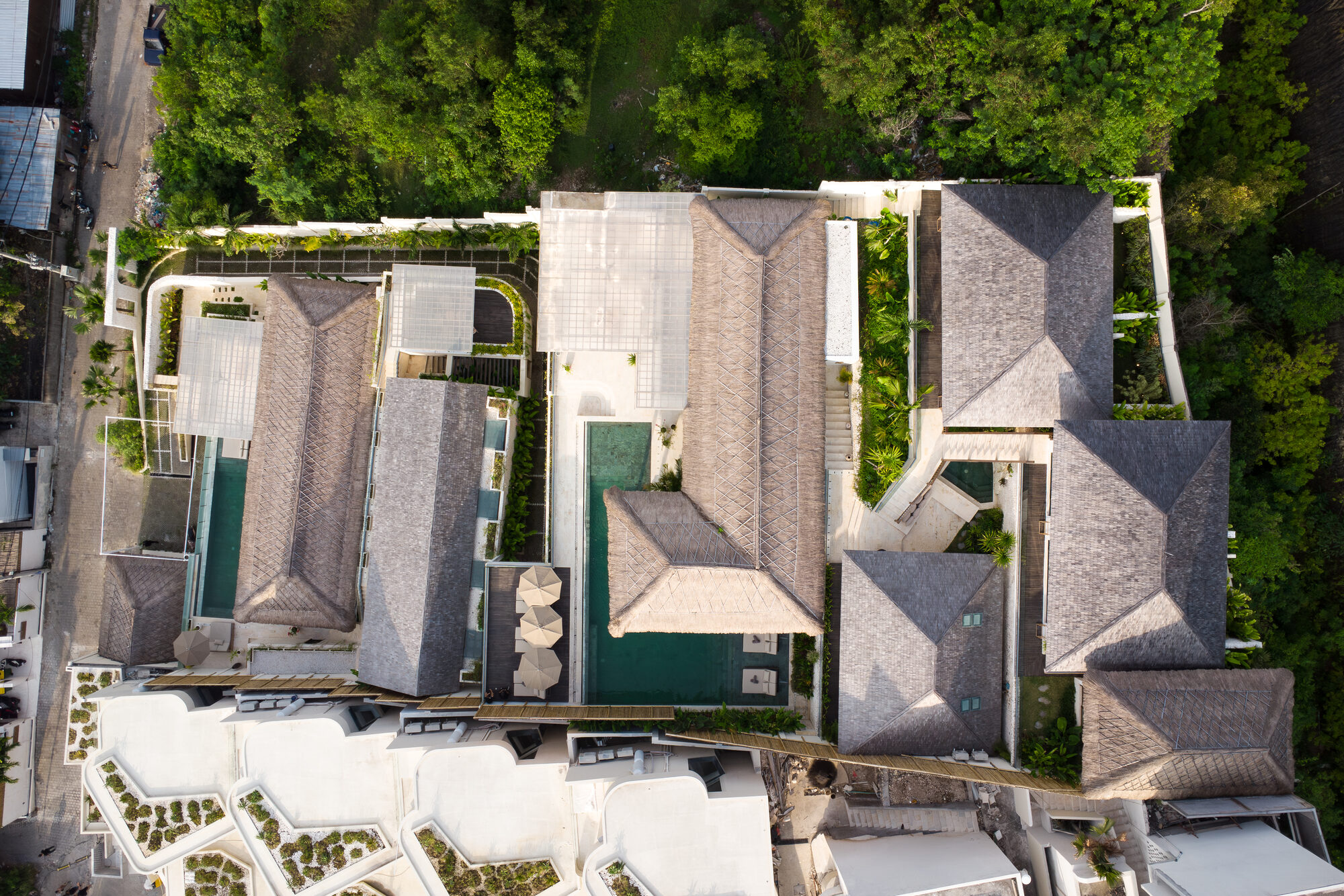 The Maison Ulu estate at golden hour — both villas in one frame.