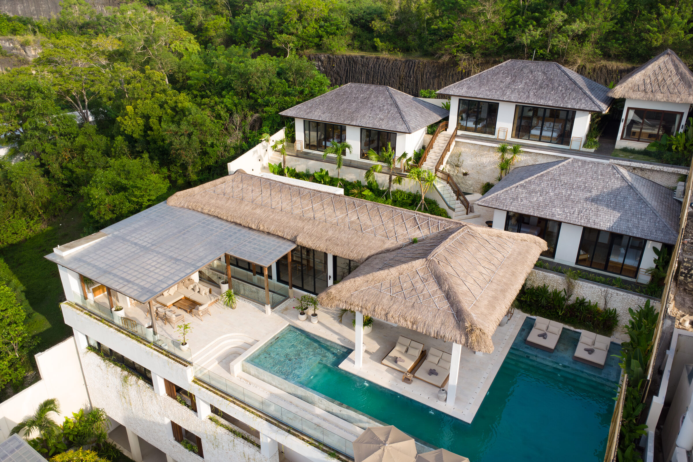The Maison Ulu estate at golden hour, looking across the cliffs of Uluwatu.