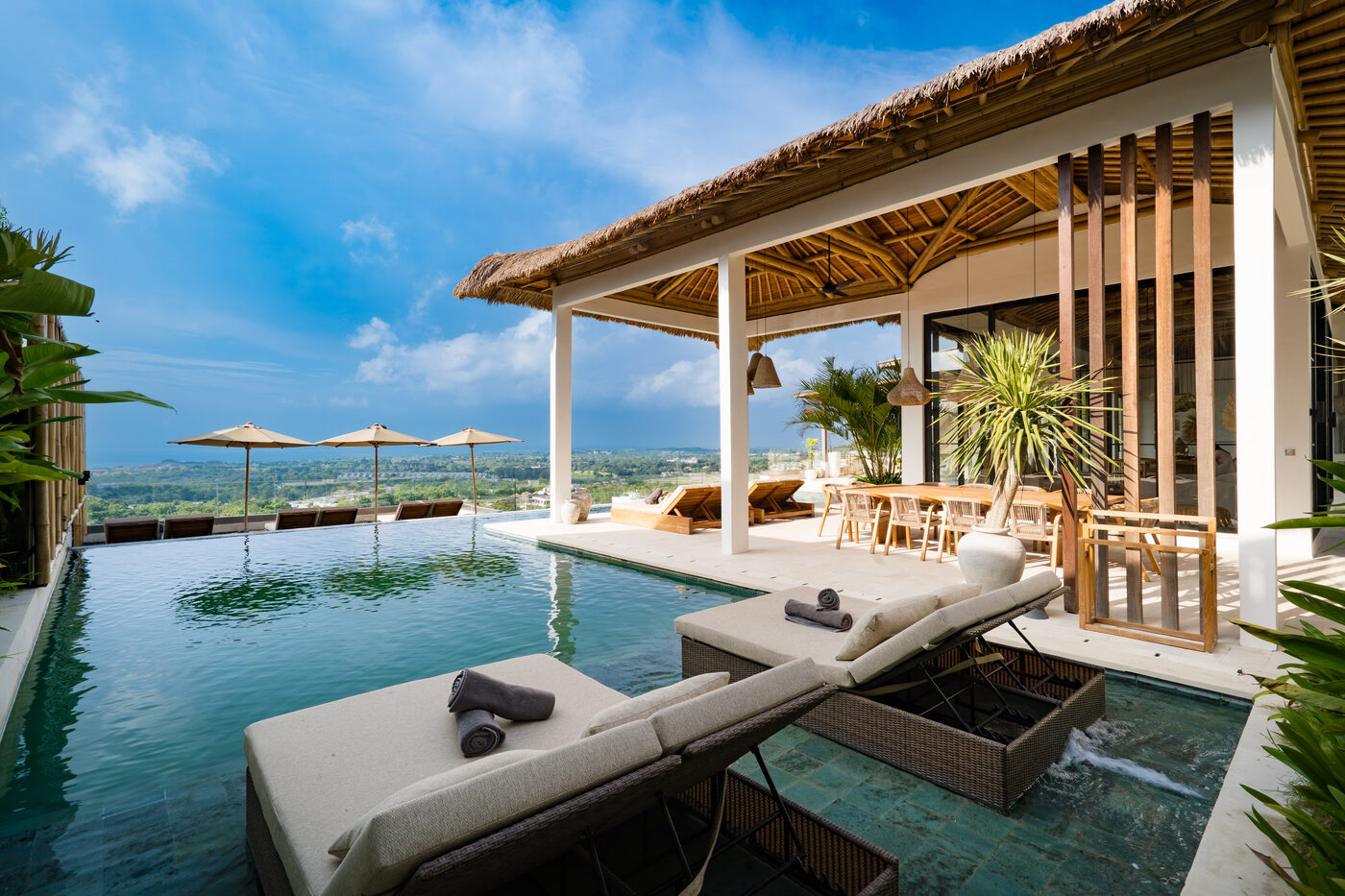 The infinity pool at Maison Ulu, the cliffline beyond.