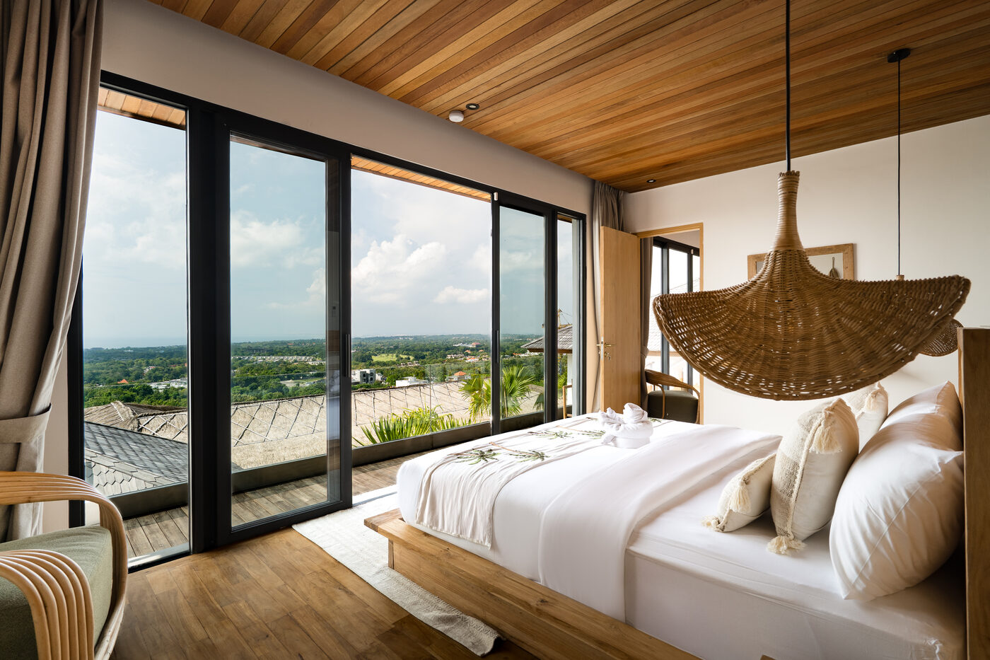 A suite at Maison Ulu Satu, hillside light through linen.