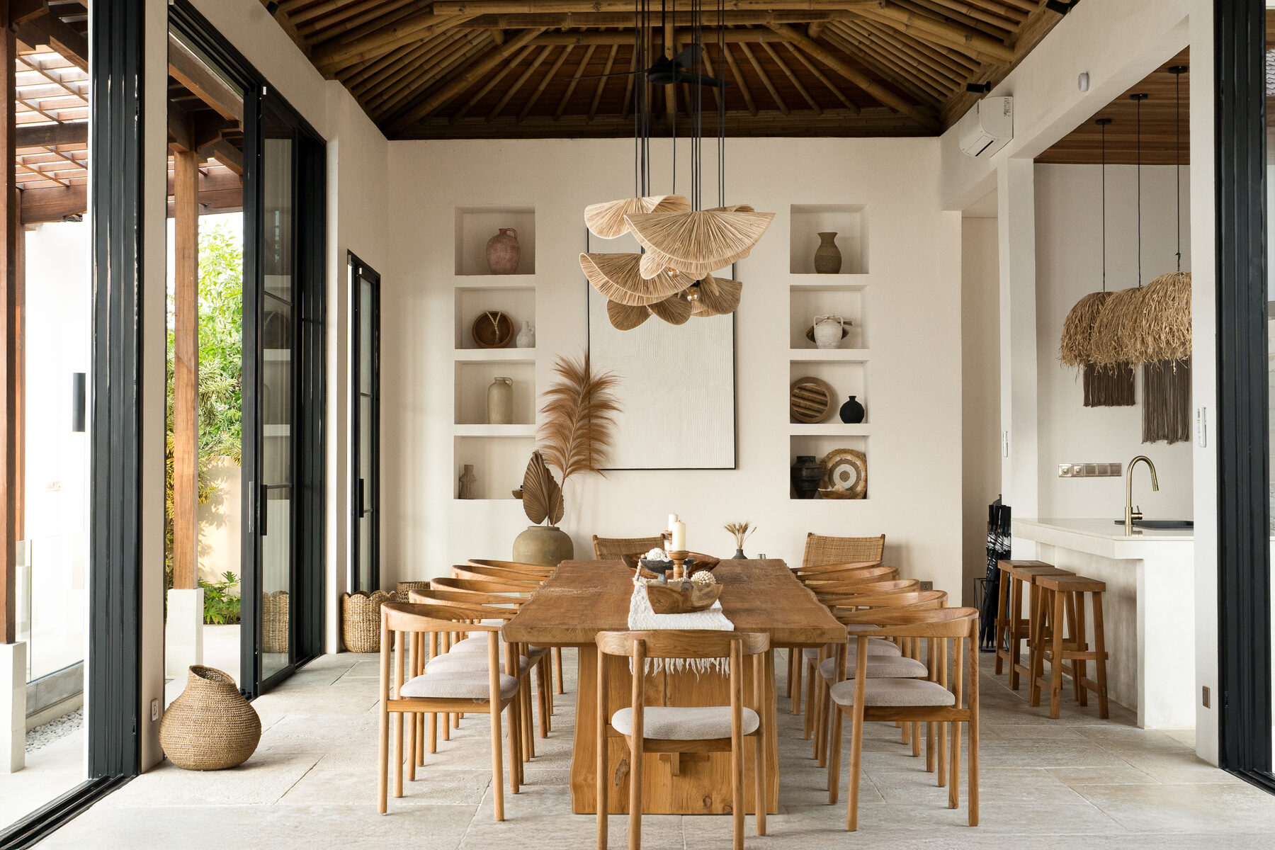 A living space at Maison Ulu Satu, high ceilings, hillside light.