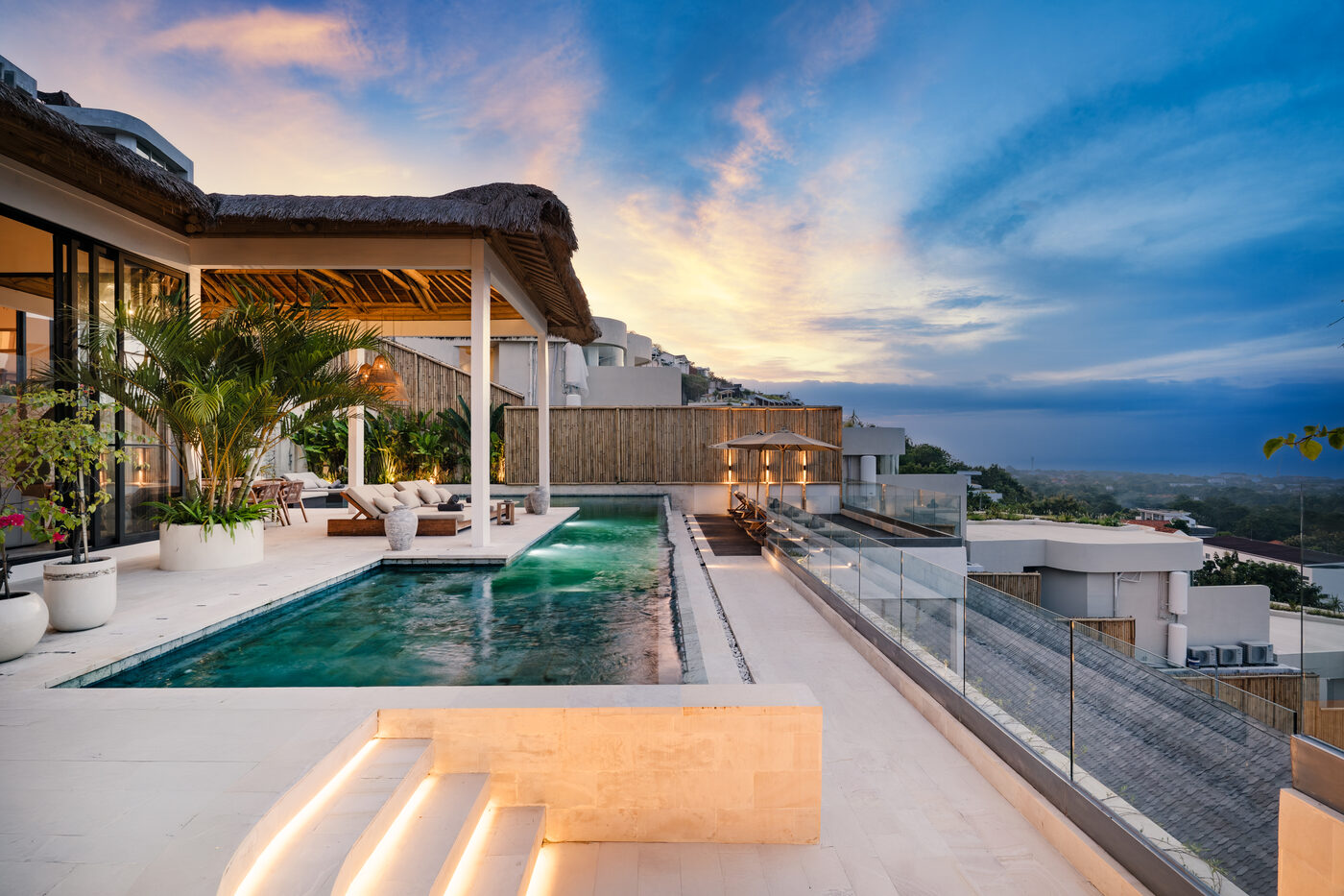 An outdoor bath at Maison Ulu Satu, framed by hillside greenery.